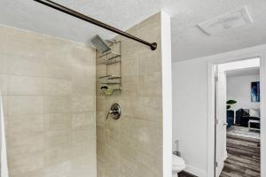 a bathroom with a shower with a toilet in it at Luxury Miami Retreat in North Miami +59 photos