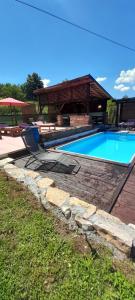 a swimming pool in a yard with a gazebo at Vikendica i vajat Vrbica in Kalesija