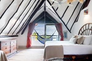 a bedroom with a bed and a large window at Casa de Los Vientos Soliman Bay in Tulum +58 photos