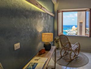 a room with a table and a chair and a window at Terrammare del Golfo in Castellammare del Golfo
