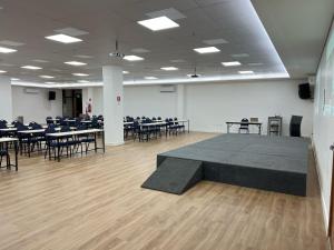 a large room with tables and chairs and a stage at Imperial Hotel in Imperatriz +119 photos