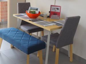 a table with two chairs and a laptop on it at Apartamento Casa Garzon in Girardot