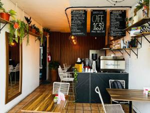 a restaurant with a counter with chairs and a table at Leveli Coliving in Guadalajara