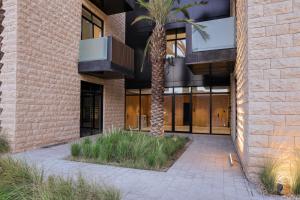 a palm tree in front of a building at شقة بغرفة نوم واحدة بطابع فندقي in Riyadh
