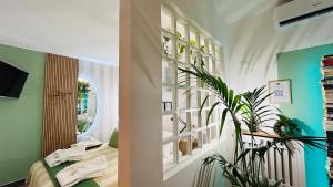 a room with a bed and a plant in it at BBSUITE21 Maranello in Maranello