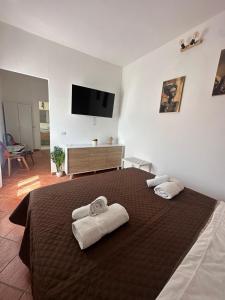 a bedroom with a large bed with towels on it at Crispi Guest House MMG in Olbia +35 photos