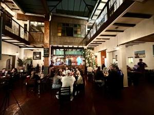 a group of people sitting at tables in a restaurant at Hostal Restaurant La Cigale in Cuenca