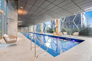 a large swimming pool in a building at Wsp high rise luxury 2b2b unit in Melbourne