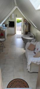 a living room with an awning and a tiled floor at les volets bleus in Saint-Guénolé