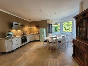 a kitchen with a table and a table and chairs at Villa Gesine FeWo plus in Braunlage