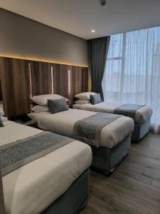 Postel nebo postele na pokoji v ubytování فندق نسمات مكةNasamat Makkah Hotel