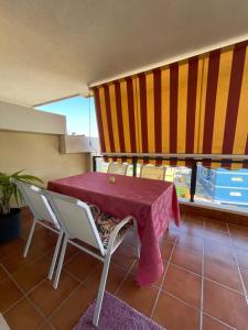 einen Tisch mit einem roten Tischtuch auf dem Balkon in der Unterkunft Villa Matilde in San Luis de Sabinillas