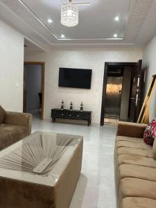 a living room with a couch and a tv at Apartamento Nador AlJadid 2 in Nador