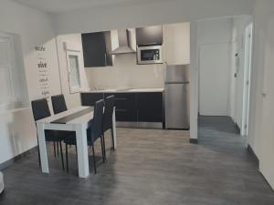 a kitchen with a table and chairs in a room at Apartamento El Rincón del Nela in Villarcayo