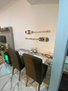 a dining room table with chairs and baseball bats on the wall at Flat Beira Mar Piedade 1603 in Recife +45 photos