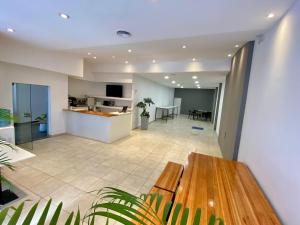 a kitchen and living room with a wooden table at ALWA Suites in Resistencia