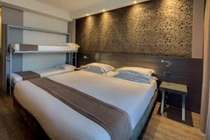 A bed or beds in a room at Best Western Plus Hotel Farnese