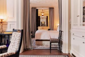 a bedroom with a bed and a mirror at At Sloane in London +72 photos