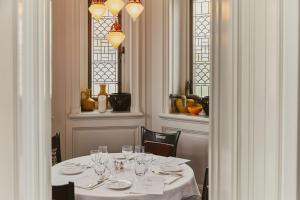 a dining room with a table with wine glasses at At Sloane in London