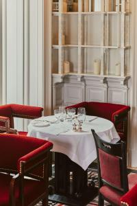 a dining room with a table with wine glasses on it at At Sloane in London