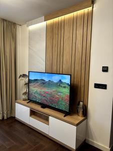 a flat screen tv sitting on a cabinet in a living room at Zlatibor Wayout, Spa & Wellness in Zlatibor