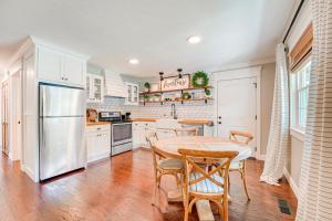 a kitchen with a table and chairs and a refrigerator at Family-Friendly Harrison Home 33 Mi to Branson! in Harrison