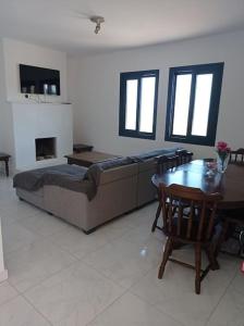a living room with a couch and a table at Pomos rockaway beach house in Pomos