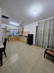 a large room with a kitchen and a dining room at Homestay Sarah Ali Kuantan 3BEDROOM 2WASHROOM SELESA,BERSIH & LUAS in Kuantan