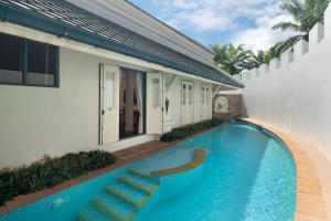 a swimming pool in front of a house at Kalanan Riverside Resort in Nonthaburi +128 photos