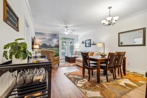 a dining room and living room with a table and chairs at Birdies & Beaches in Hampstead