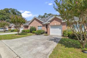 a brick house with a driveway at Birdies & Beaches in Hampstead