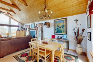 a dining room with a table and a couch at El Camino Real Retreat in Angel Fire