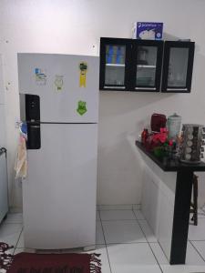a refrigerator in a kitchen with a counter at Casa Temporada Mobiliada 2 Quartos in Barreirinhas