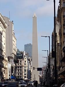 a busy city street with the washington monument in the background at Apart Bayres Obelisco in Buenos Aires +8 photos
