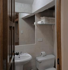 a bathroom with a toilet and a sink and a mirror at Huascaran Casa Boutique San Blas in Cusco +39 photos