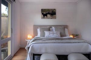 a bedroom with a large bed with two stools at The Cottage at Lake Werona in Werona