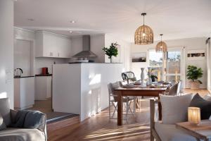 a kitchen and living room with a table and a dining room at The Cottage at Lake Werona in Werona