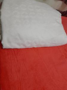 a white pillow sitting on top of a red bed at Irupe poty in Puerto Iguazú