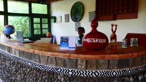 a counter with a large vase on top of it at Le Bambou Gorilla Lodge in Ruhengeri