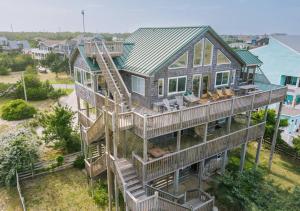 an aerial view of a house with stairs at Dune Haus - Oceanfront w Hot Tub, Private Beach in Salvo
