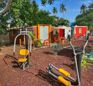 a playground with a group of camping huts at Casa Nautilus barra de navidad in Barra de Navidad