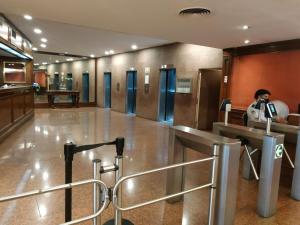 a man taking a picture of a hallway in a building at Apart Rilax in Buenos Aires
