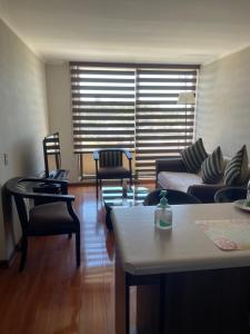 a living room with a couch and two chairs at Departamento Aníbal Pinto Concepción in Concepción