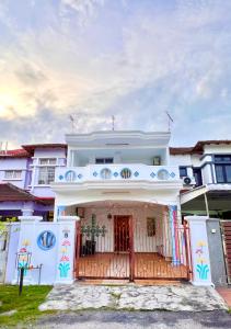 a white house with a gate in front of it at Wonder Teddy Indah House for 1-11pax at Bukit Indah Near Legoland and Ecobotanic in Johor Bahru +25 photos