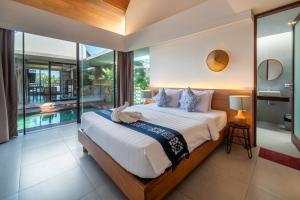 a bedroom with a large bed and a pool at Oasis Loft - Ricefield Luxe View Ubud in Ubud +38 photos