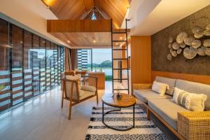 a living room with a couch and a table at Oasis Loft - Ricefield Luxe View Ubud in Ubud