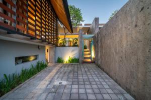 an external view of a building with a walkway at Oasis Loft - Ricefield Luxe View Ubud in Ubud