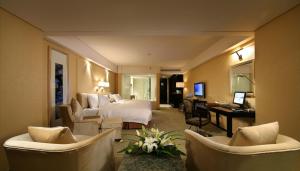 a hotel room with two beds and a desk and chairs at The Lakeview Hotel in Beijing