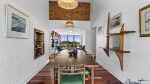 a hallway with a dining room with a table and chairs at Vintage Vista By Wine Coast Holidays in Port Willunga