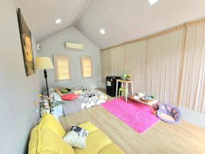 a small room with a bed and a couch at Cat A Camp - Khao Yai in Ban Suphan